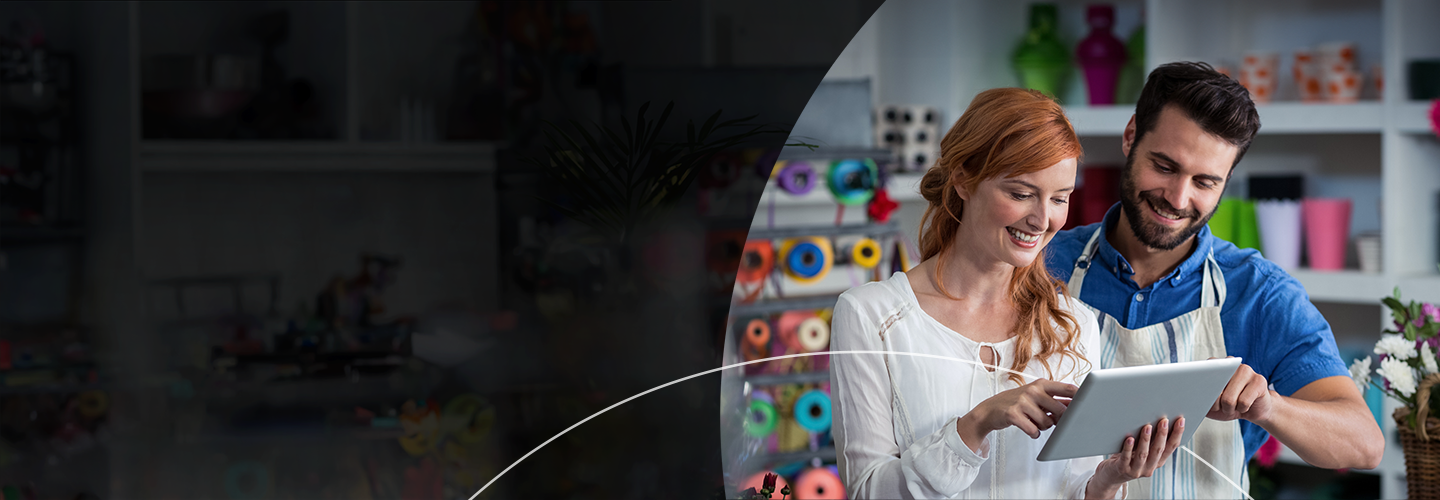 Man and a woman in a store looking at an ipad