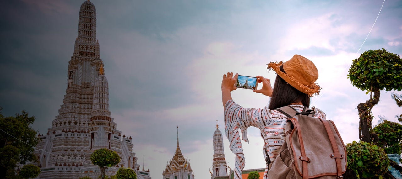 tourist taking photo of temple
