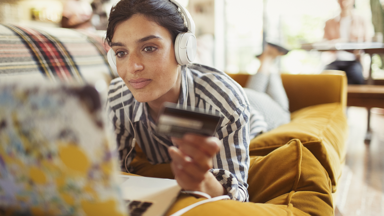 Woman lie on sofa online shopping