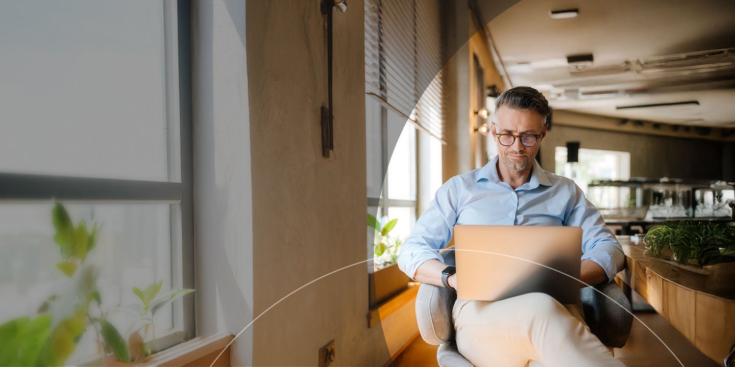 man in glasses working in cafe