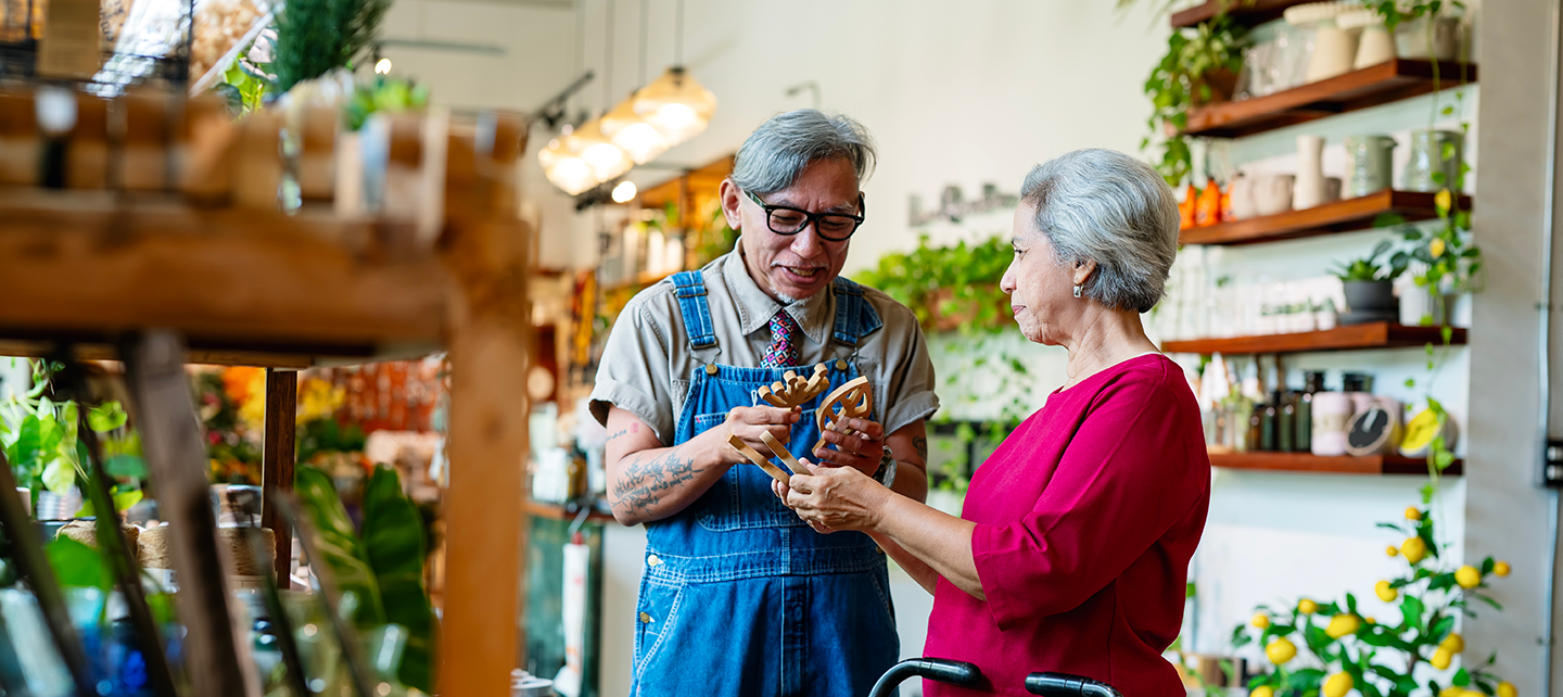Older woman working with an older store clerk to make a selection