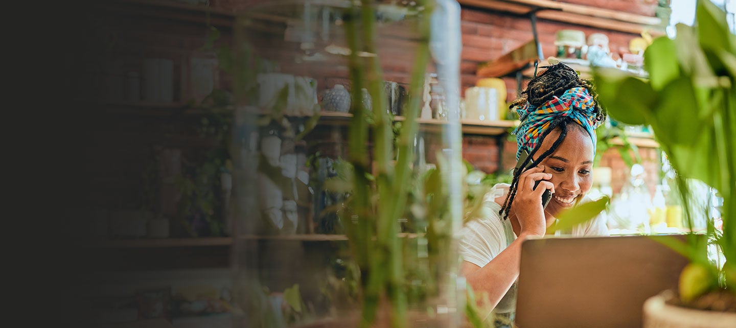 Small business owner talking on a phone in flowershop.