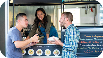 Two customers ordering from food truck.