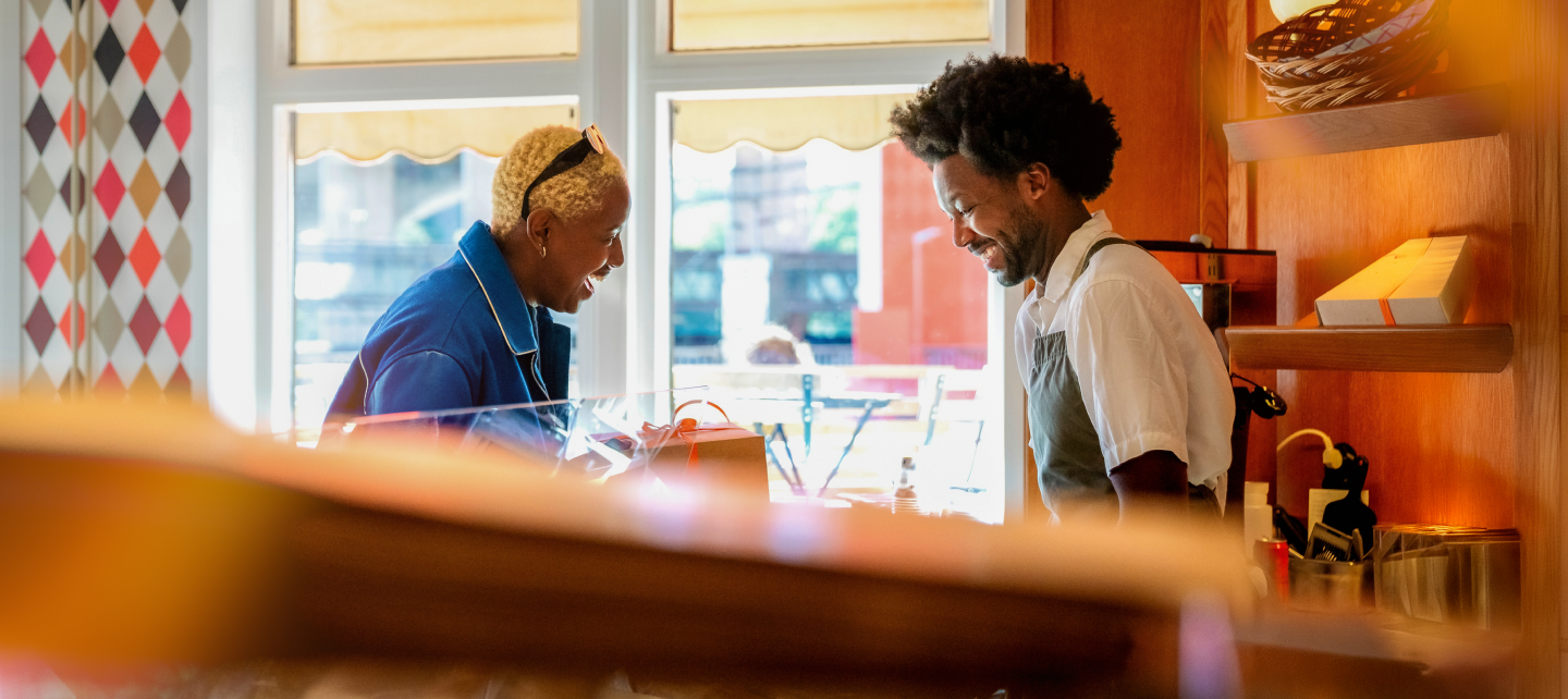 Barista serving someone at a local coffee shop