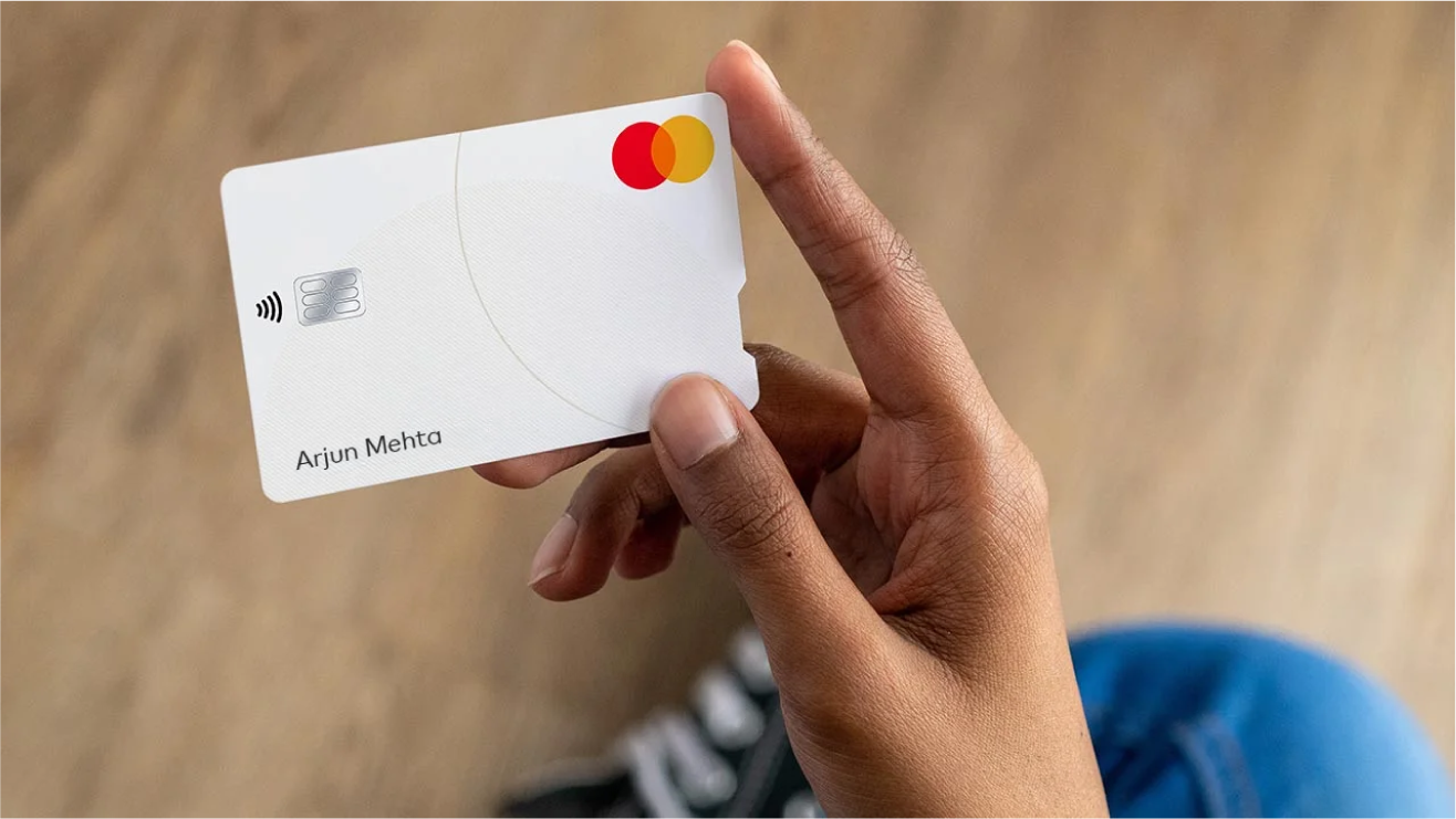 A hand holding a Mastercard.