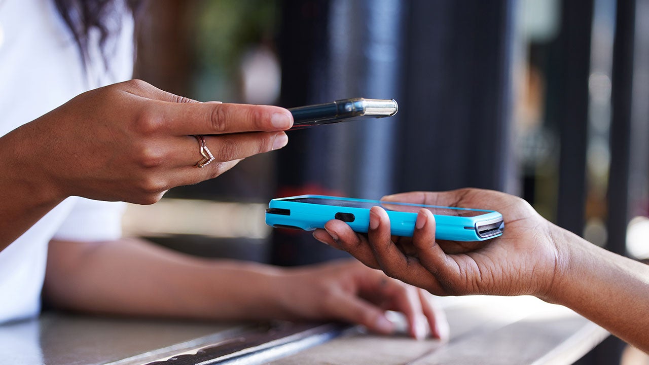 One phone tapping on another phone to pay.