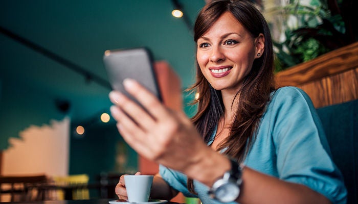 Woman ordering at a restaurant using her phone