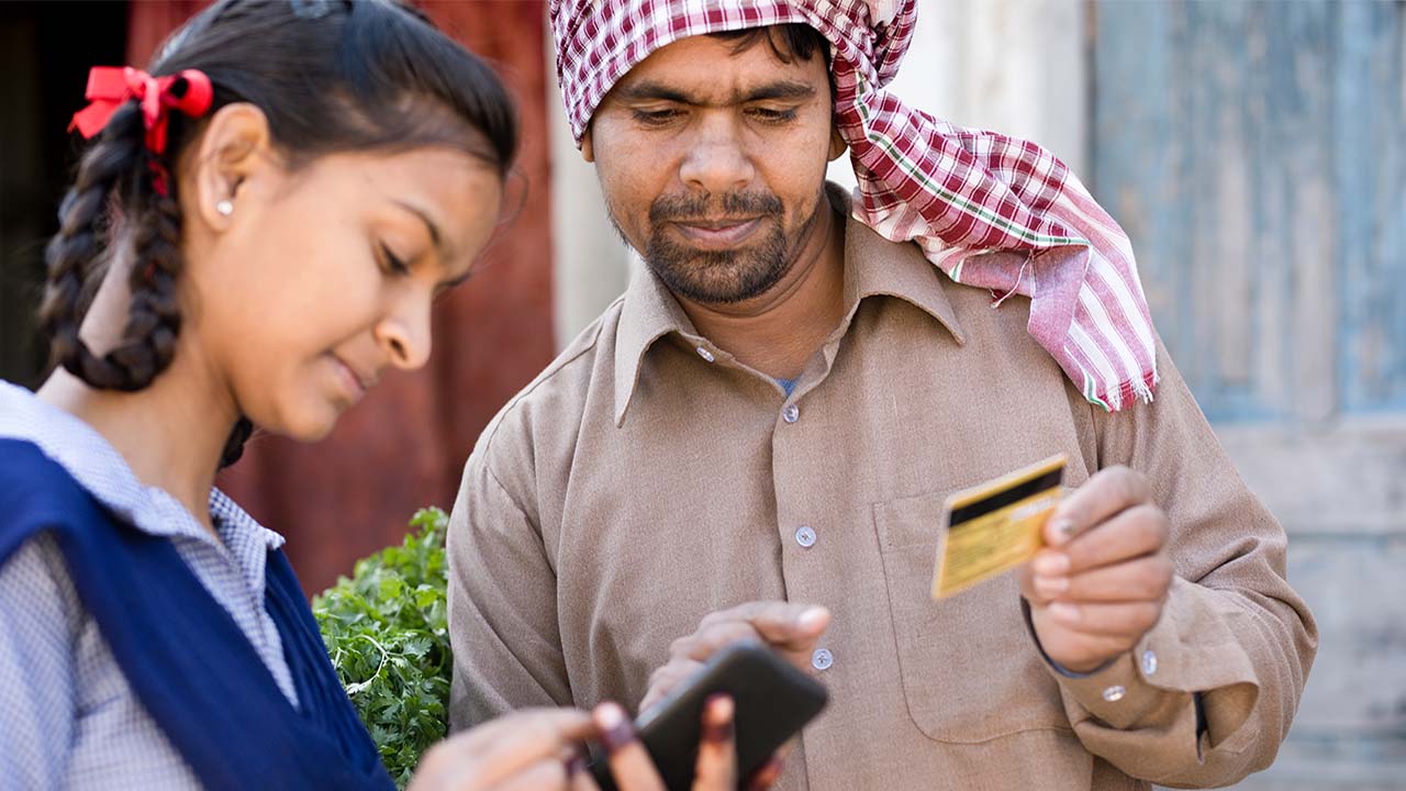 School girl helping father with online payment.