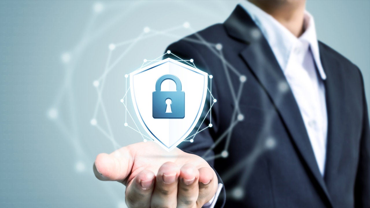 Businessman holding shield protect icon