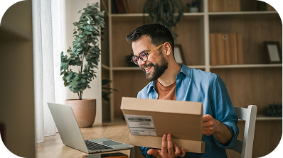 A man with a computer and package