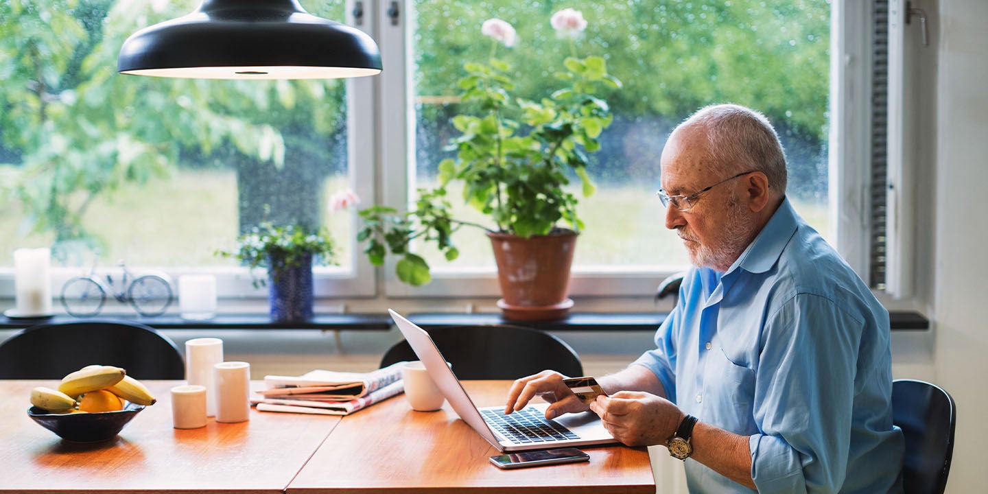 Man making an online payment on his laptop at home