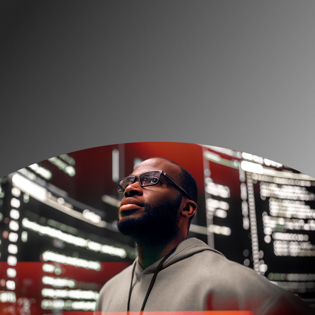 Man looking up surrounded by data on screens