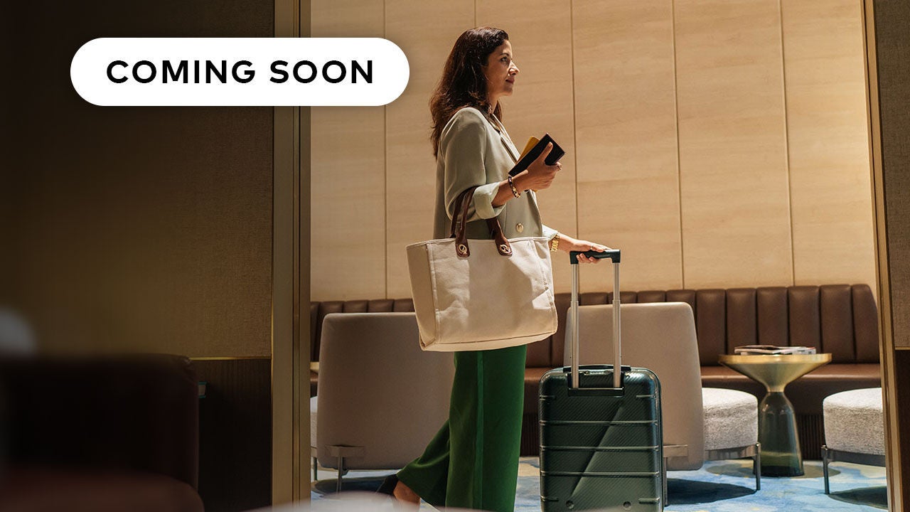 Woman with luggage in hotel.