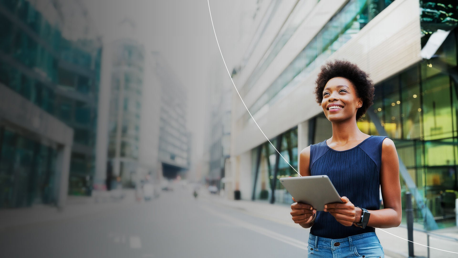 Woman holding tablet in front of office buildings.