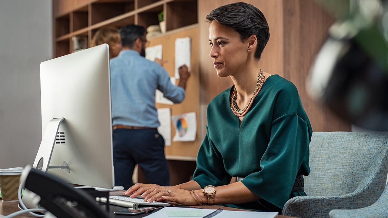 Businesswoman working on a MAC.