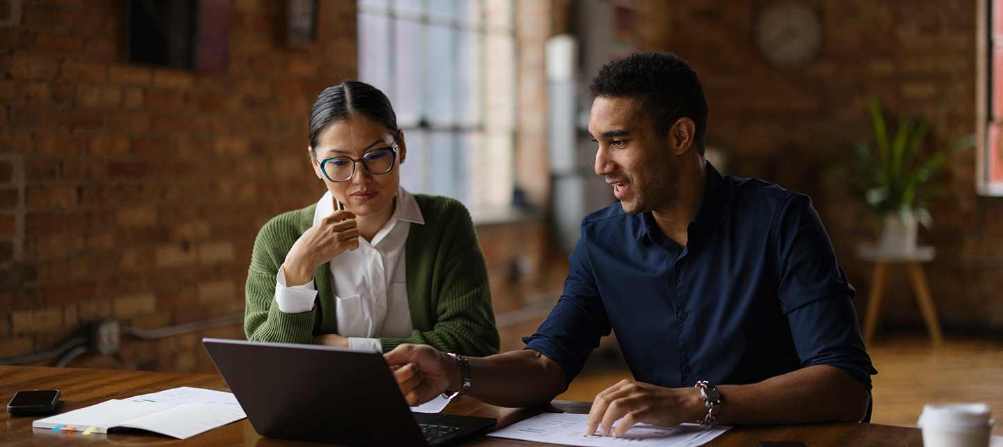 Two coworkers collaborating in a modern office