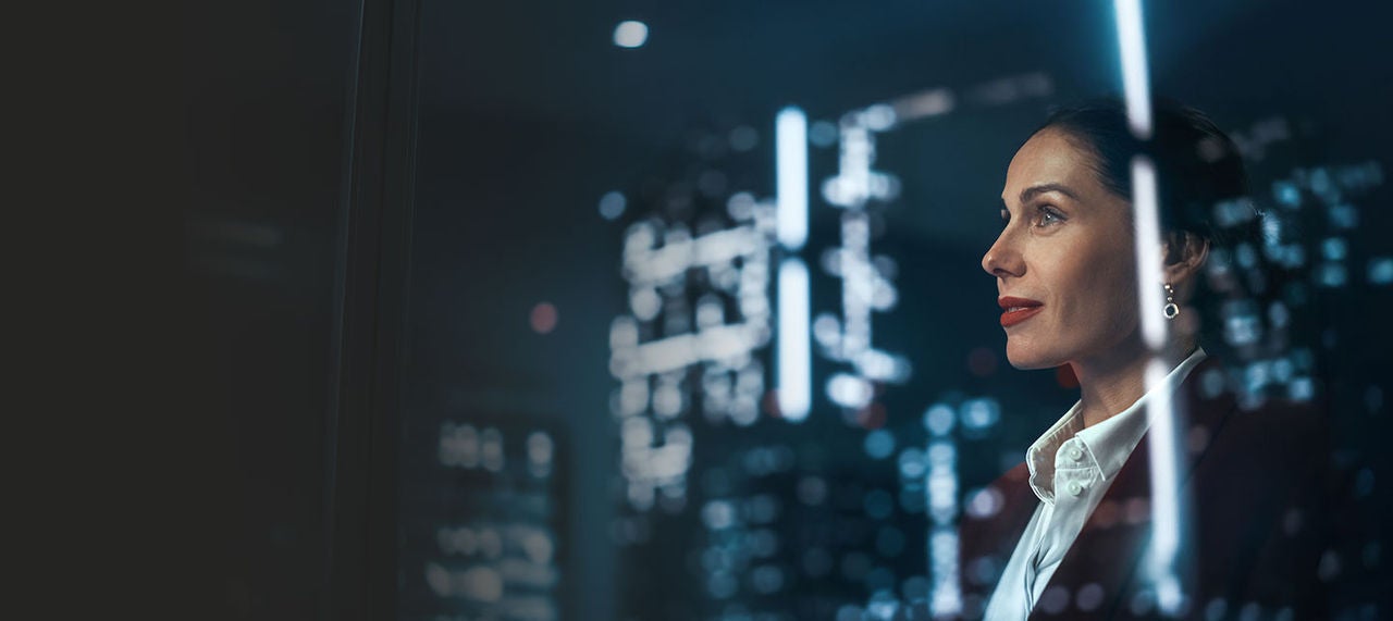 Woman looking out into technology window.