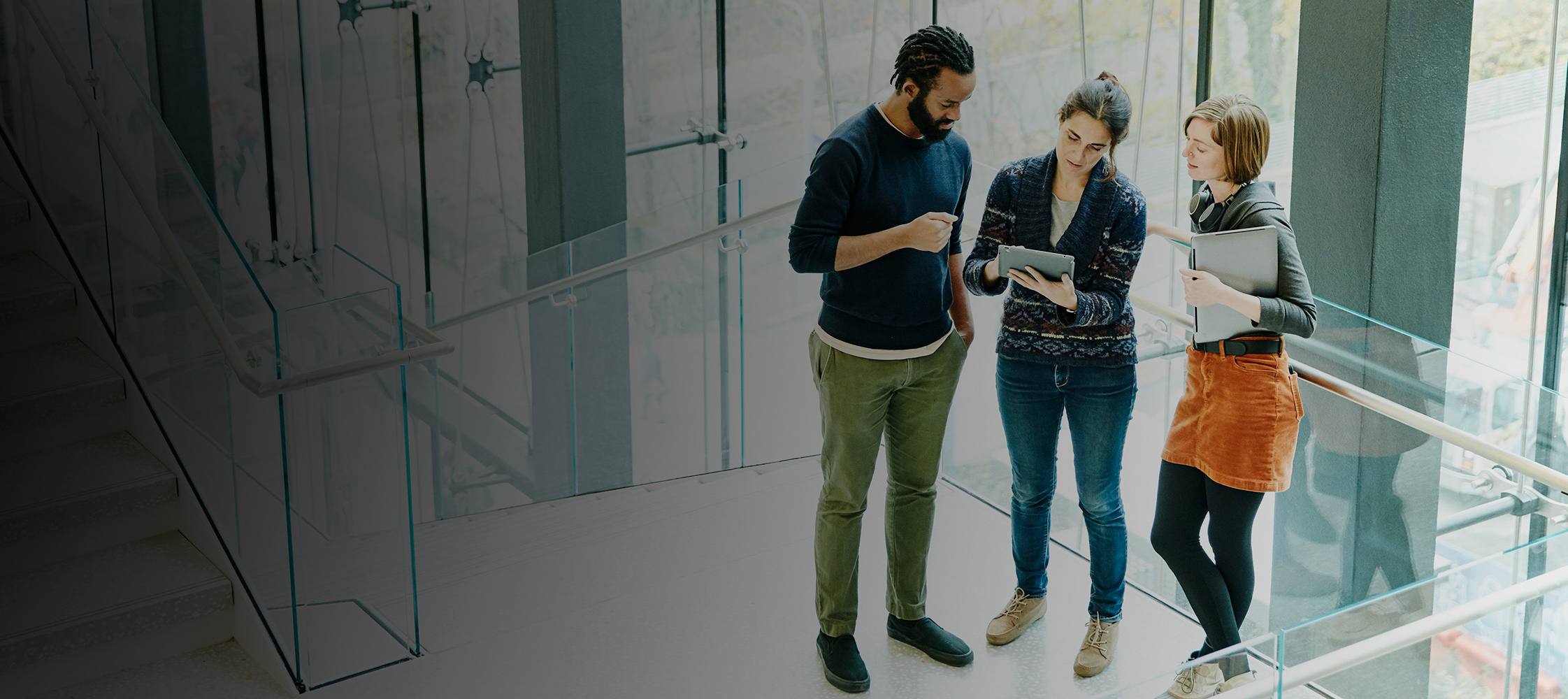 People in the stairwell of the office talking