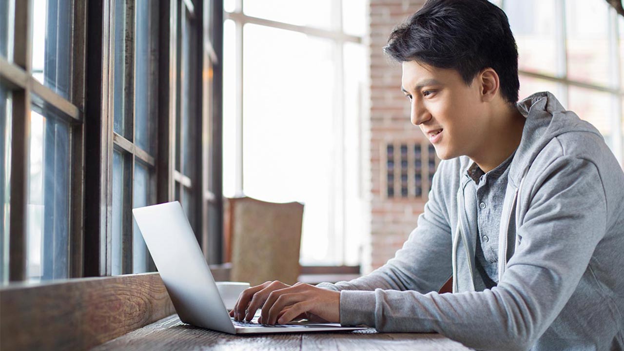Young man working on Macbook.