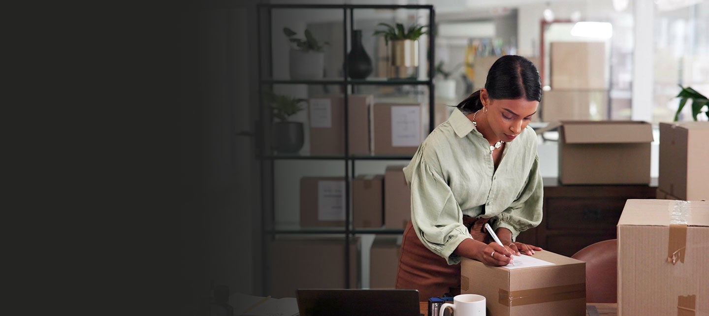 Small business owner packing shipments.
