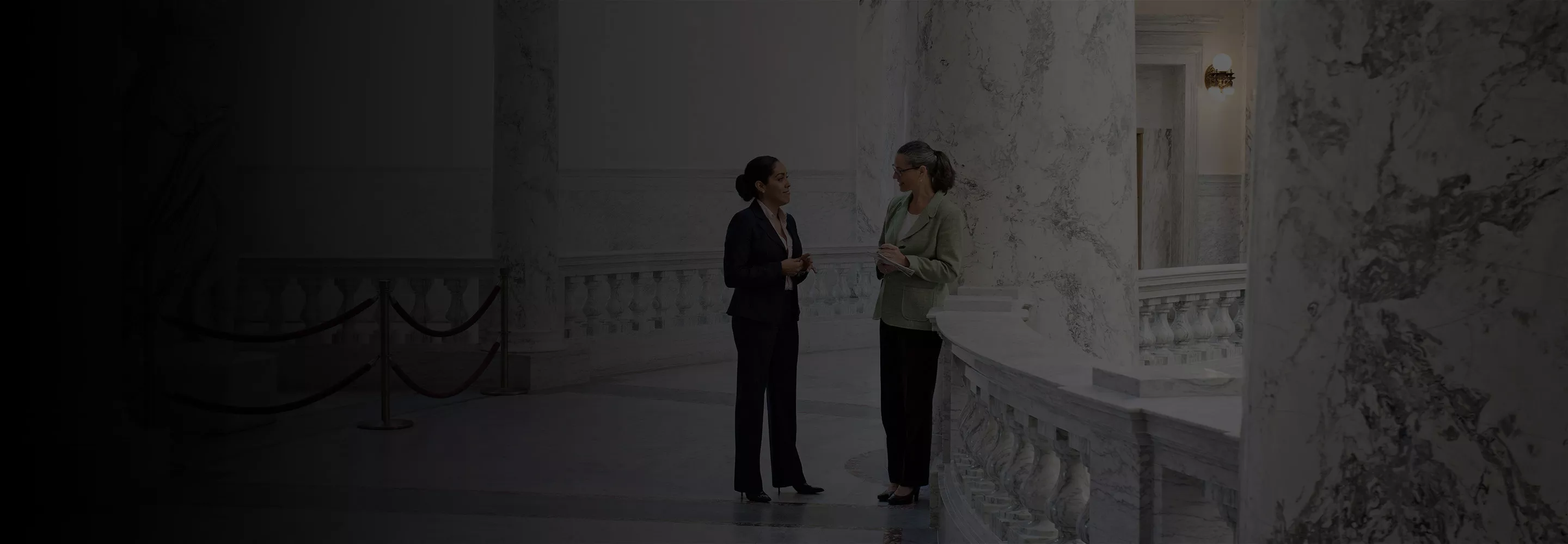 Women talking at a classic building