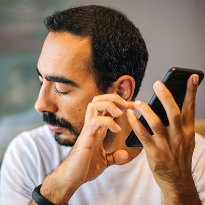 Man tapping something on mobile phone.
