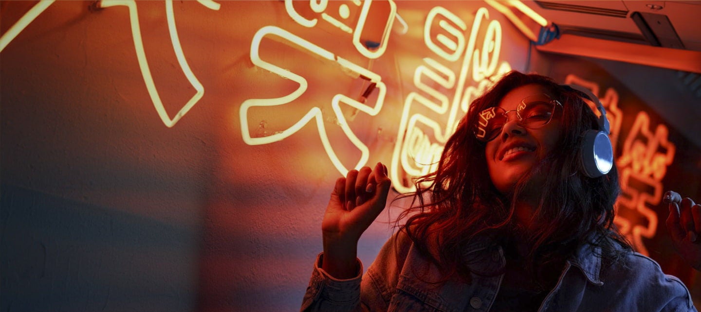 smiling woman dancing neon in lights