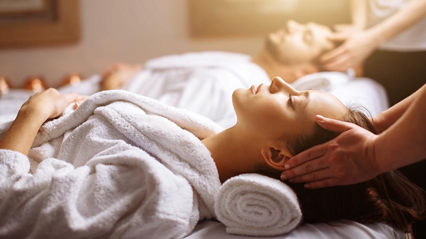 Couple relaxing on a massage table.