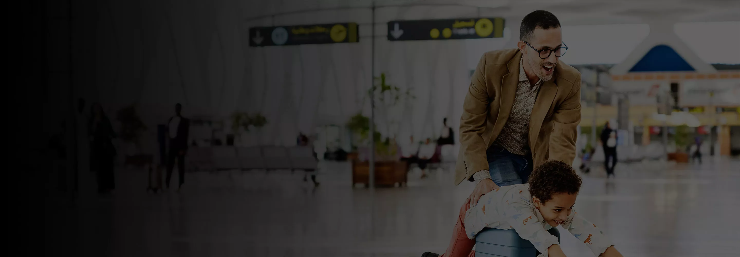 Father and son playing at an airport