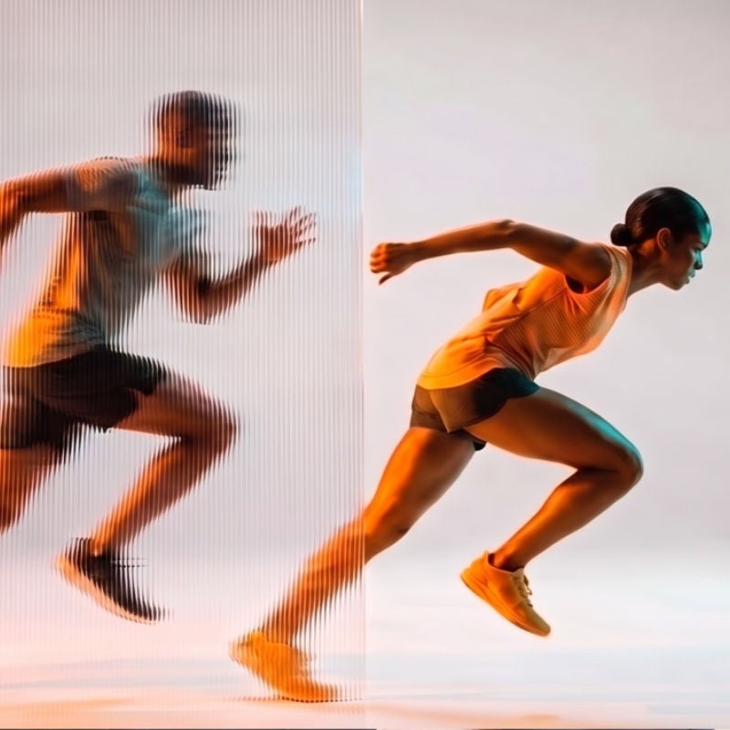 A woman in running gear leads others behind her. 