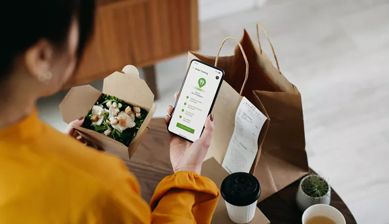 Woman looking at restaurant order in phone