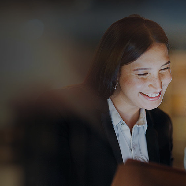 woman smiling in front of an screen