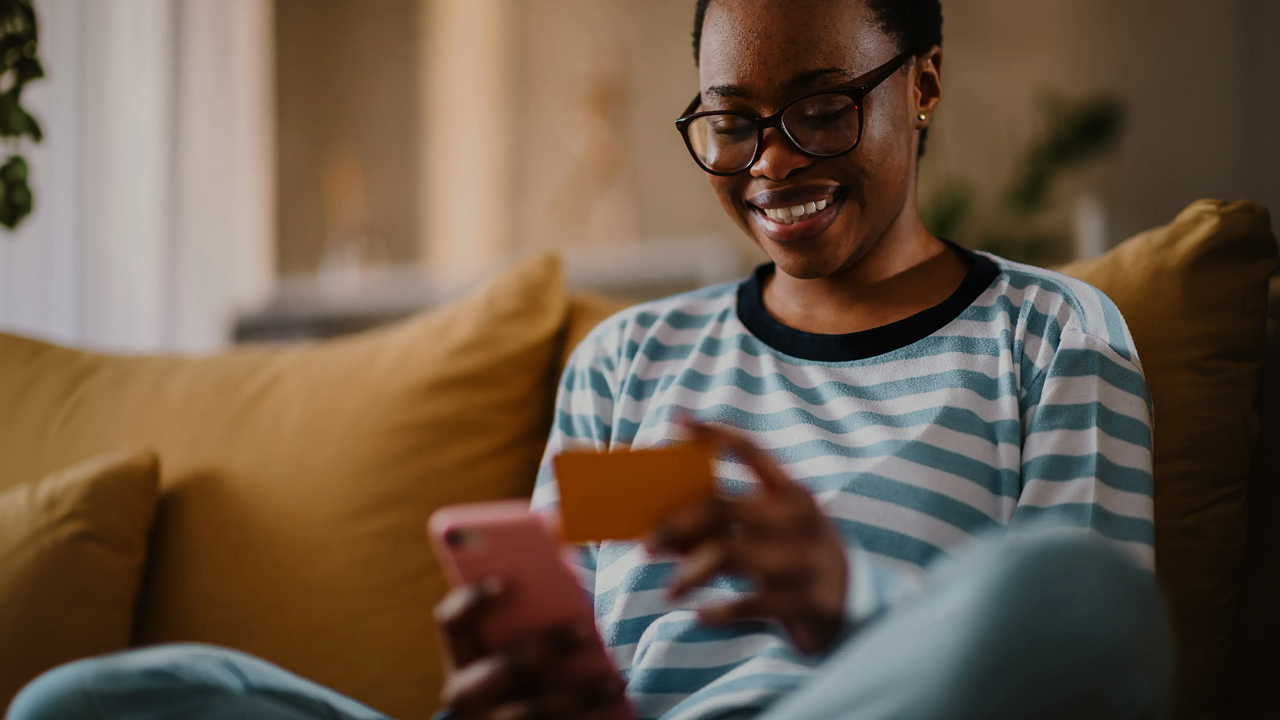 Woman paying with card on phone