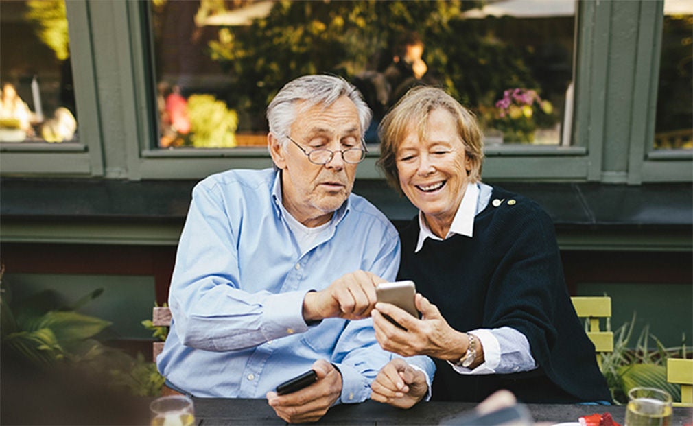 Senior couple using phone