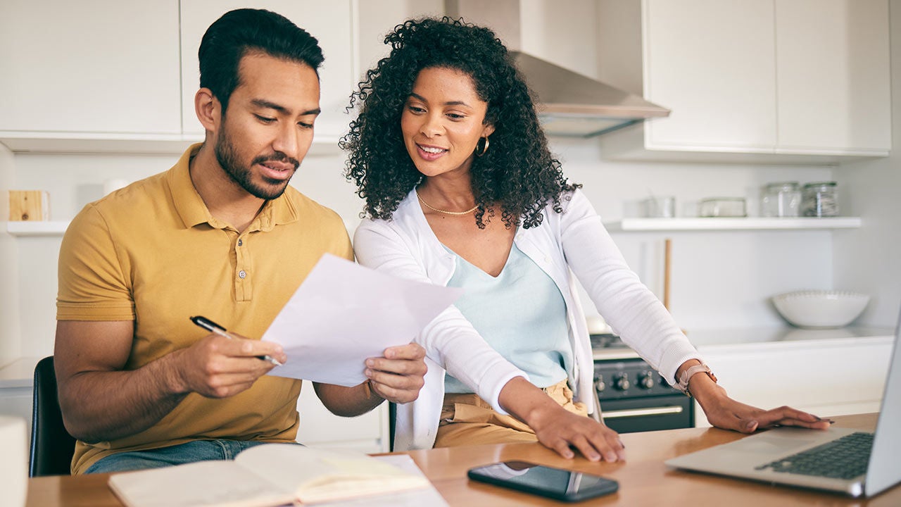 A couple at home reviewing bills.