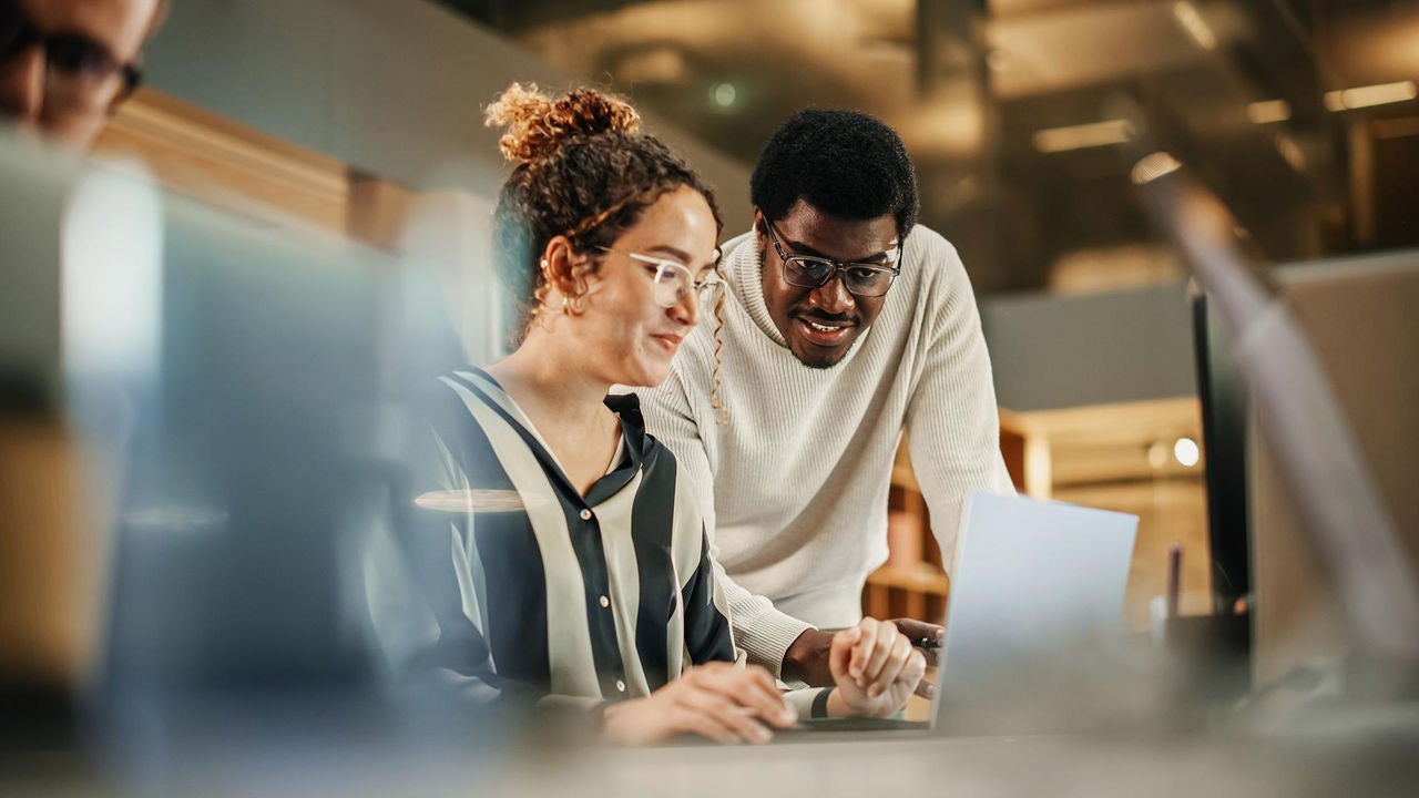 Two people working on a computer