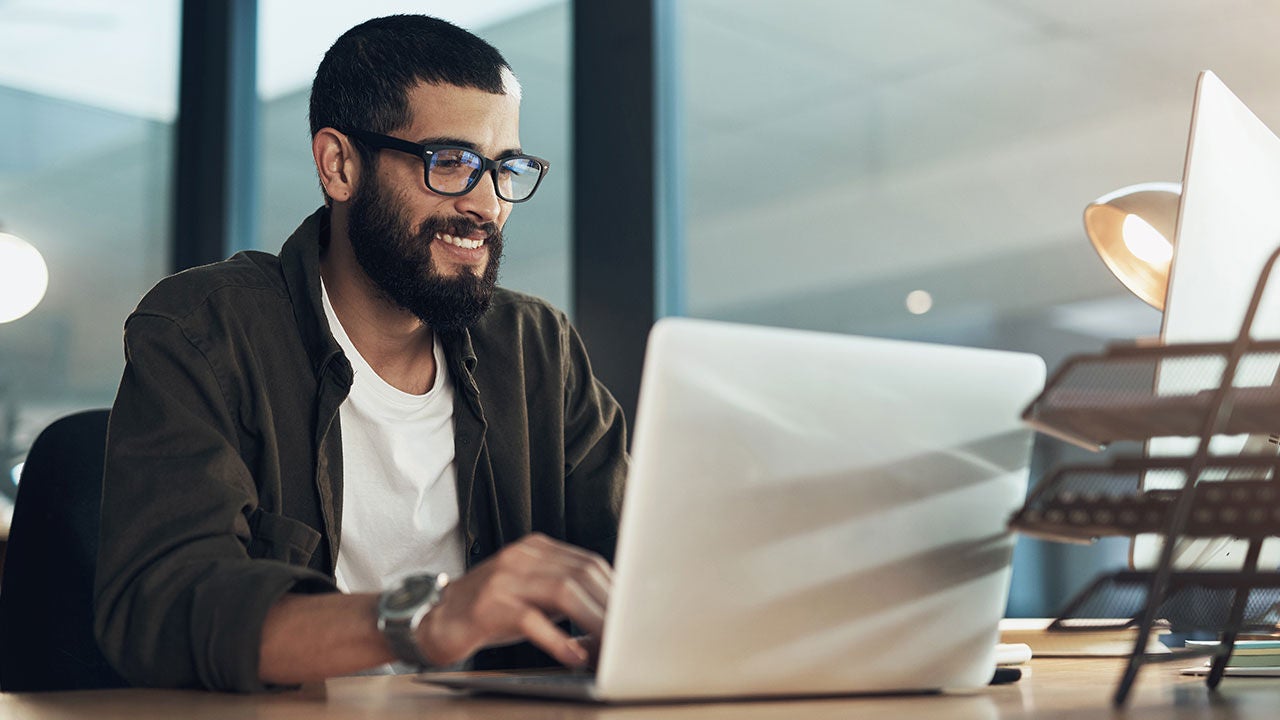 Man using laptop at work.