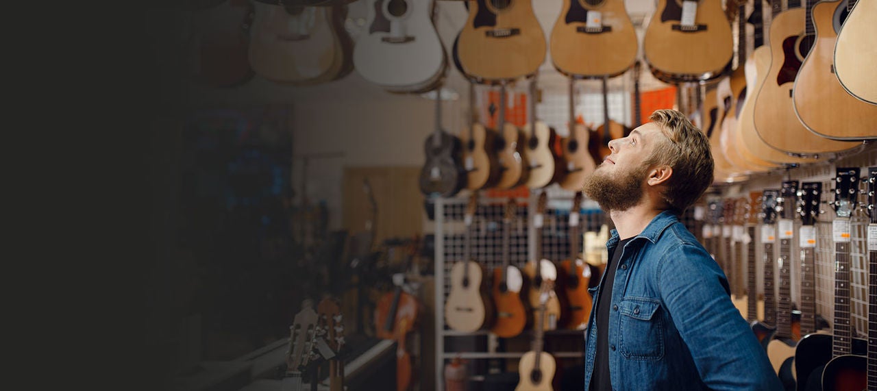 Owner of guitar store in his shop.