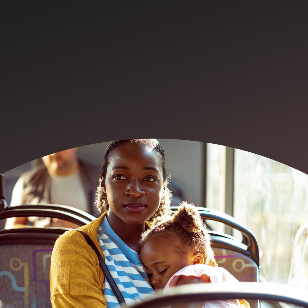 Woman with daughter sitting in a bus.