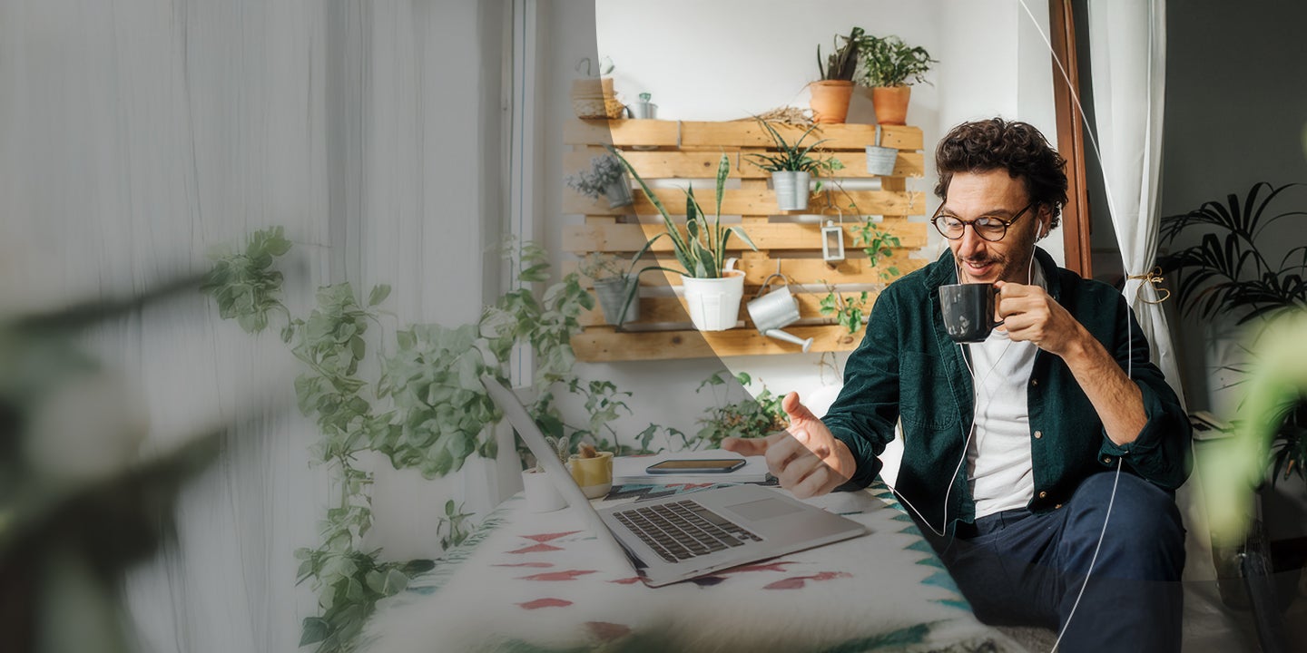 Man with laptop sipping coffee.