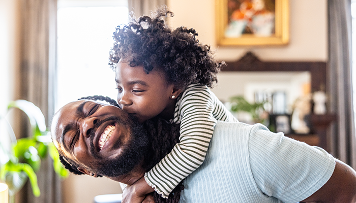 Father giving his daughter a piggyback ride