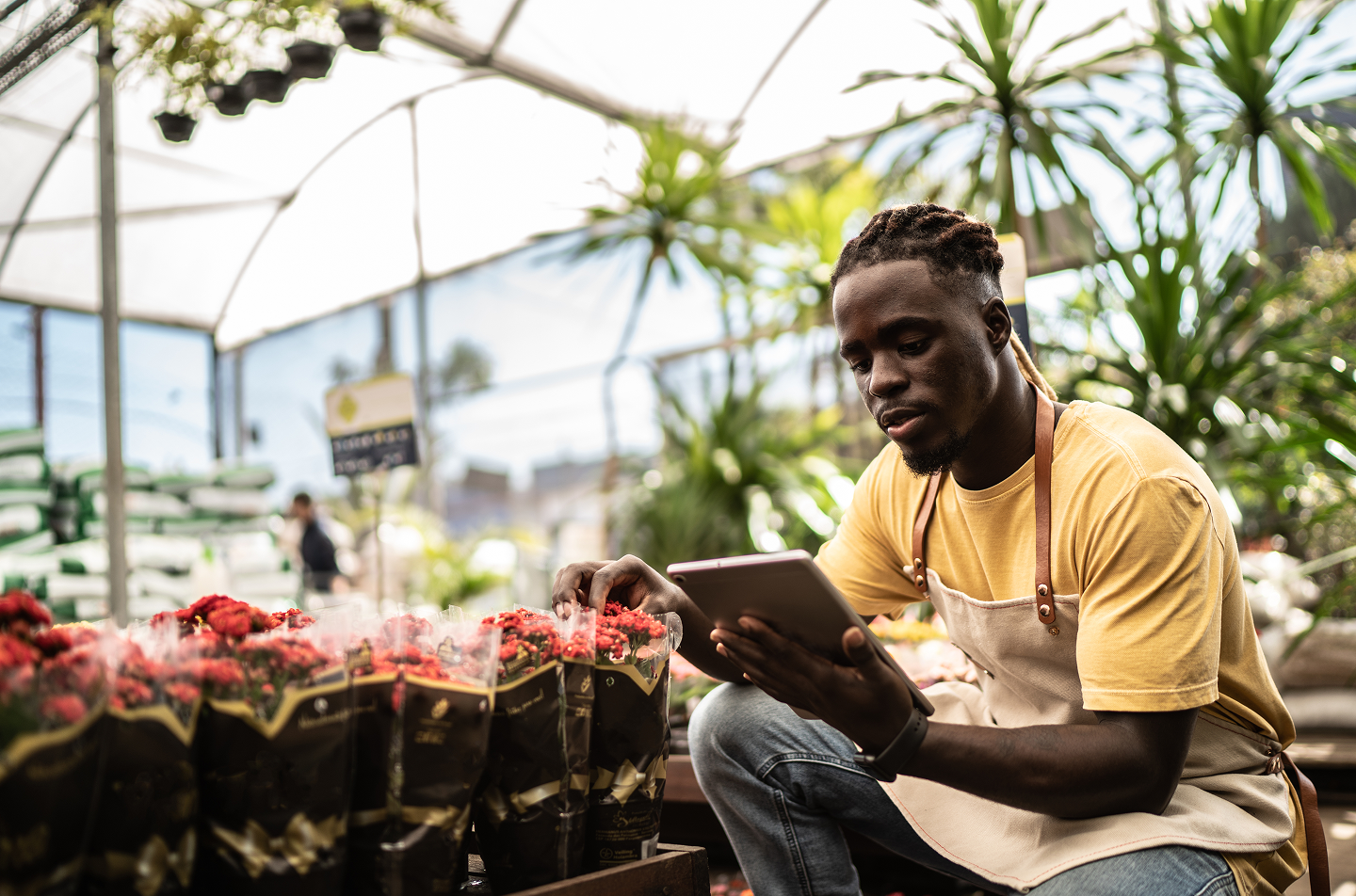 Man on tablet in garden store