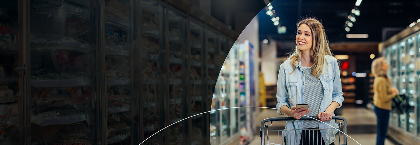 Woman walking through the grocery store with a cart