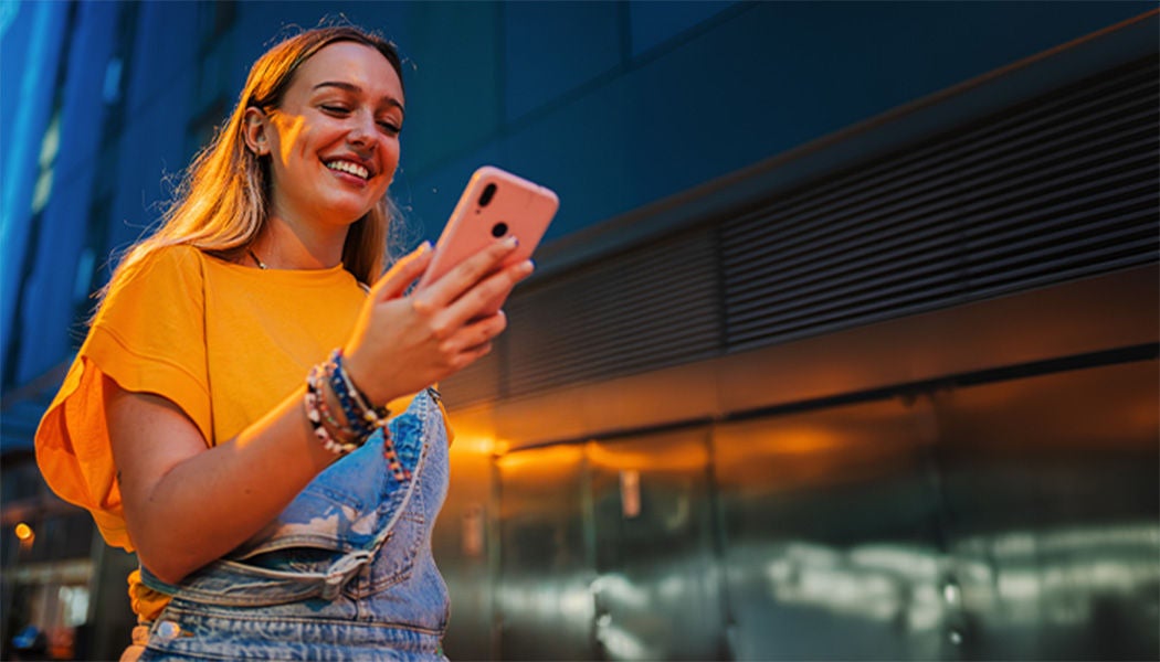 Woman wearing an overall and an orange shirt