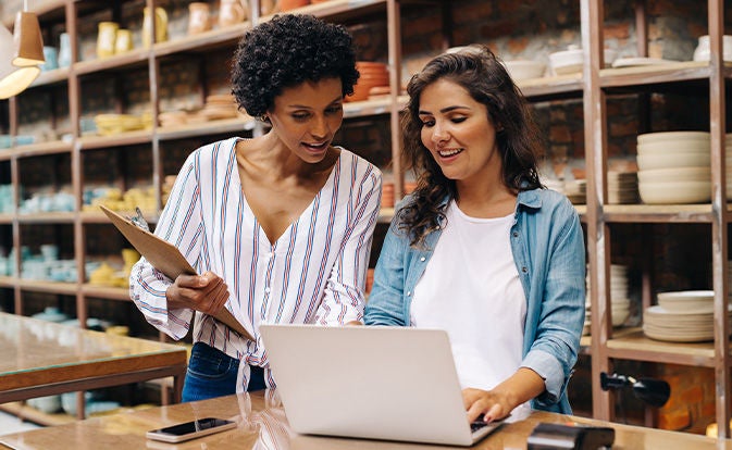 Two women discussing while looking at a computer screen