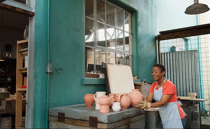 Artist working outside her pottery studio.