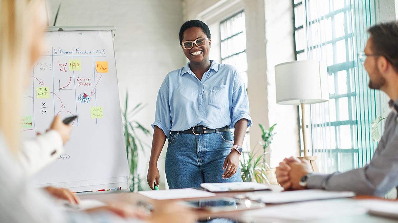 Joyous woman presenting to colleagues.