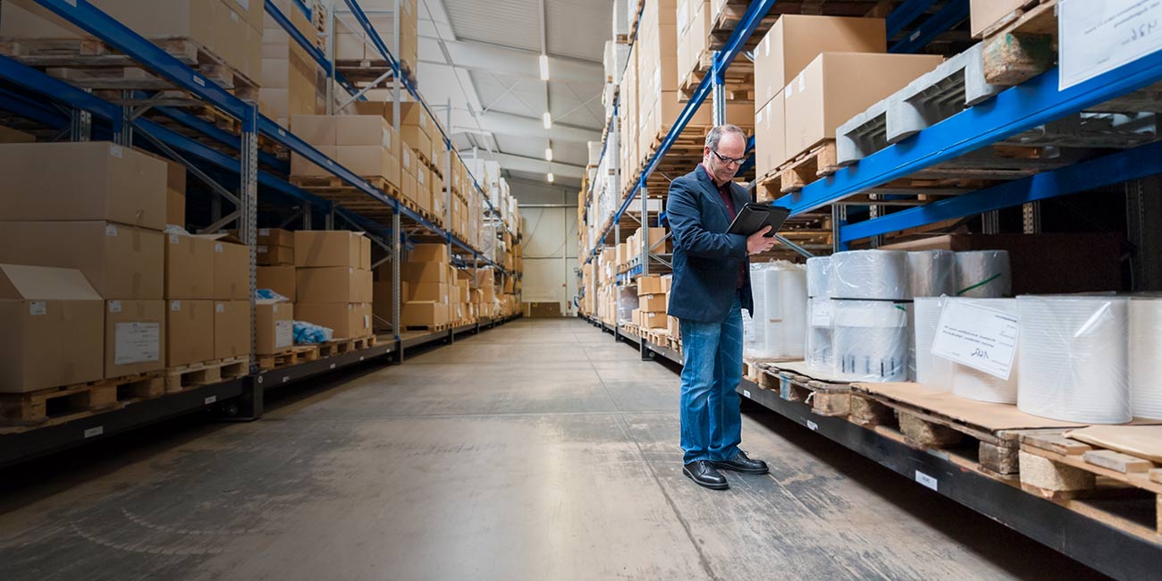 Woman smiling looking at someone next to her facing out a window.