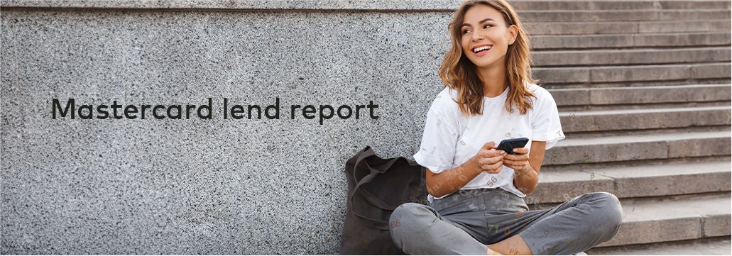 Woman sitting on stairs outside online banking on phone