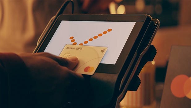 Tapping Mastercard on payment terminal.